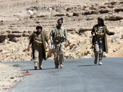 Pro-government army soldiers walk on a road in Fardhat Nahm area, which has recently been taken by the army from Houthi rebels, around 60km (40 miles) from Yemen's capital Sanaa, February 20, 2016. REUTERS/Ali Owidha