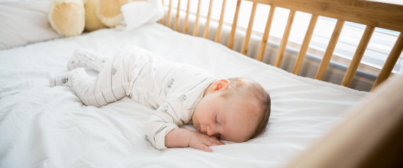 Baby boy sleeping on a cradle at home