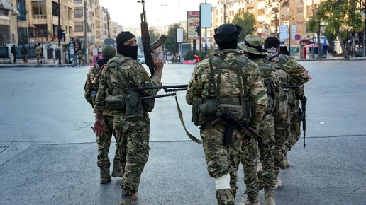 Anti-government fighters patrol in central Aleppo on November 30, 2024. Jihadists and their Turkish-backed allies breached Syria's second city of Aleppo on November 29, as they pressed a lightning offensive against forces of the Iranian- and Russian-backed government. (Photo by Muhammad HAJ KADOUR / AFP)